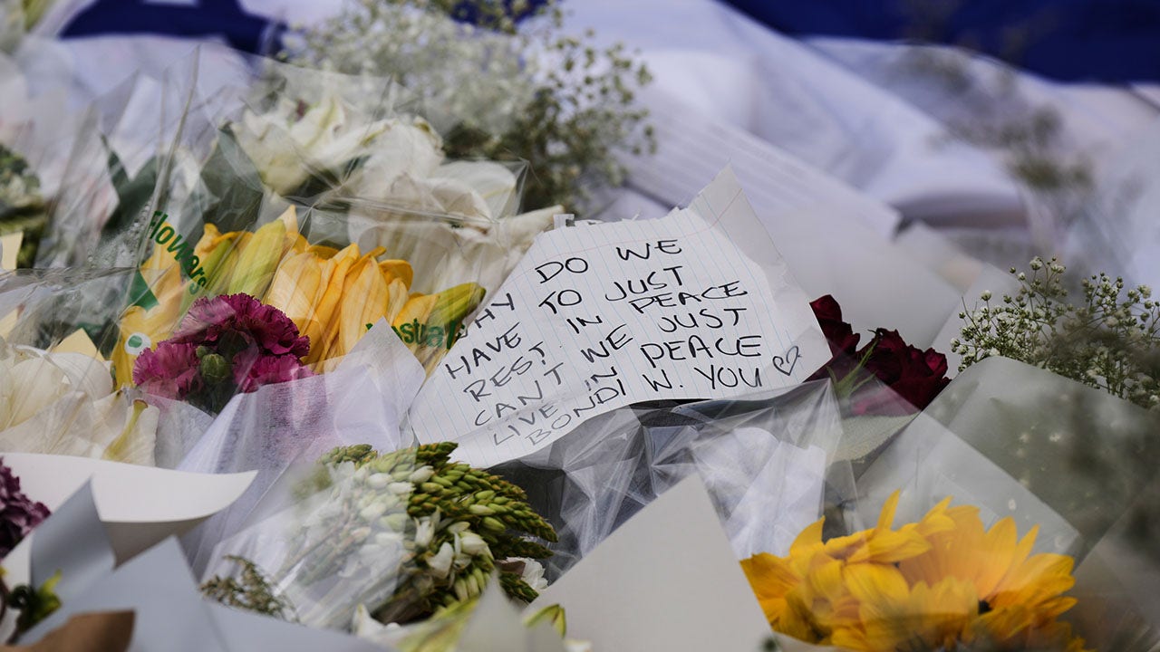 A note is left attached to a flower at a tribute for shooting victims outside the Bondi Pavilion at Sydney's Bondi Beach, Monday, Dec. 15, 2025, a day after a shooting. (AP Photo/Mark Baker)
