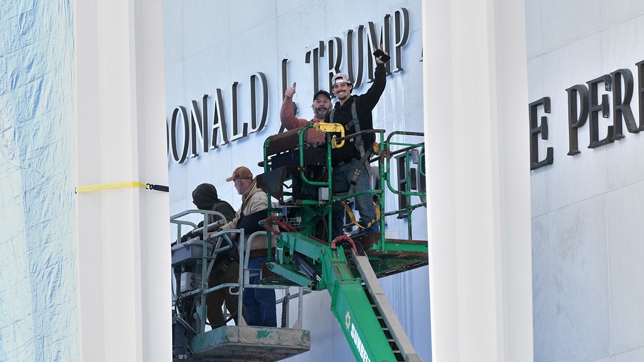 Workers install Donald J. Trump above the current signage on the Kennedy Center on Friday, Dec. 19, 2025, in Washington. (Jacquelyn Martin/AP Photo)