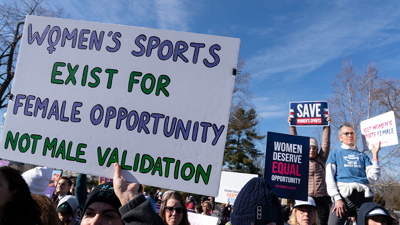 Protesters gather outside the Supreme Court as it hears arguments over state laws barring transgender girls and women from playing on school athletic teams, Tuesday, Jan. 13, 2026, in Washington. (Jose Luis Magana/AP)