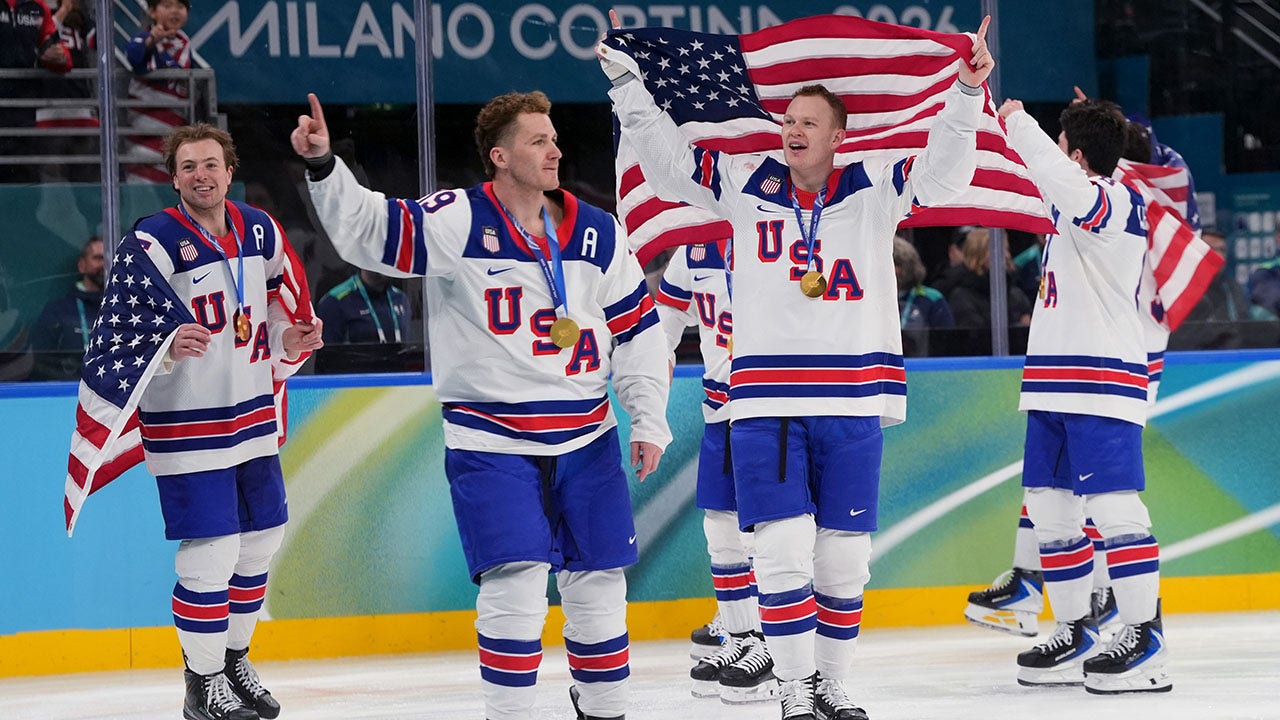 United States players, including Brady Tkachuk (7) of the United States, celebrate after defeating Canada in the men's ice hockey gold medal game during the Milan Cortina 2026 Olympic Winter Games at Milano Santagiulia Ice Hockey Arena on Feb. 22, 2026. (Amber Searls/Imagn Images)