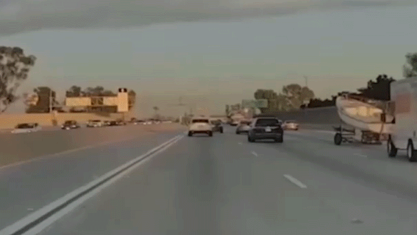 Boat trailer crashes over center median on busy California freeway, driver doesn't stop