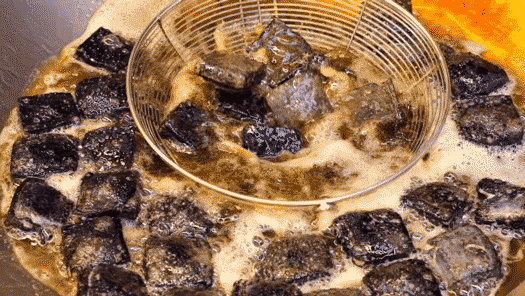 GIF of cook frying stinky tofu