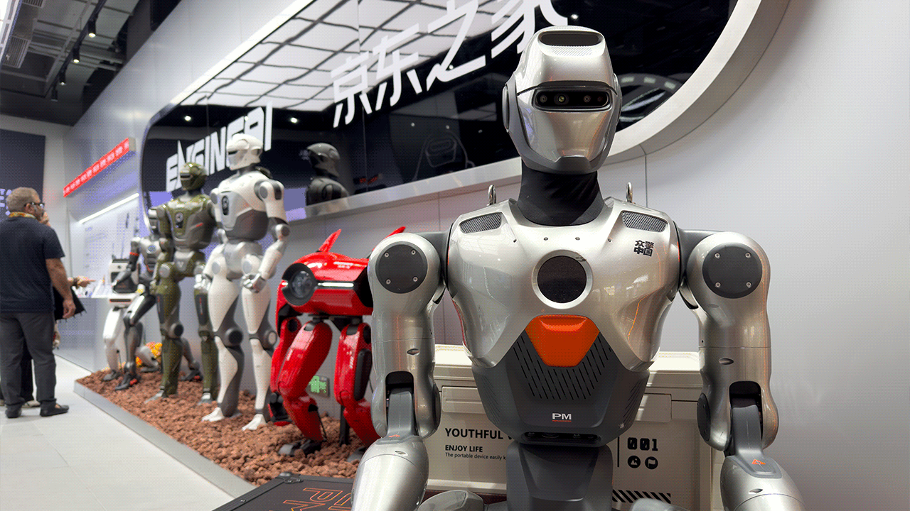 The EngineAI PM01 robot stands in front of a row of other robots.