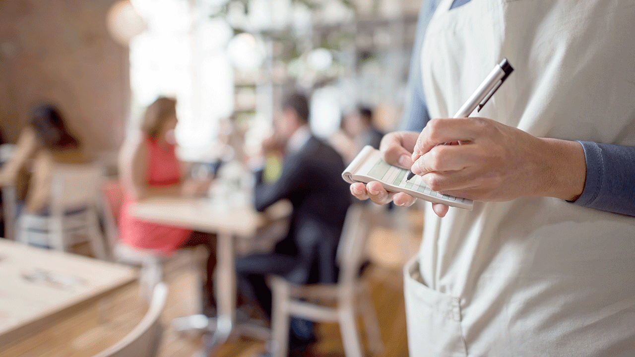 A waiter taking an order