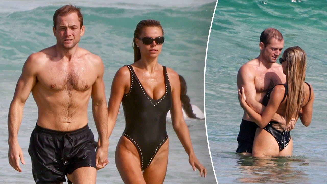 Brooks Nader and Taron Egerton pack on PDA at Bondi Beach in Australia