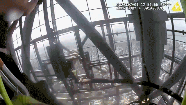 Two people taken into custody after climbing to the top of Empire State Building with massive banner