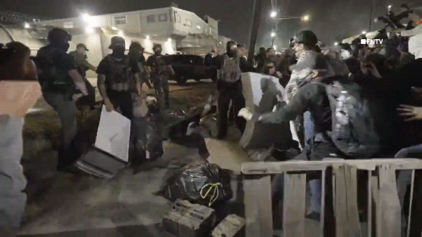 Agitators toss mattresses and other objects at ICE agents