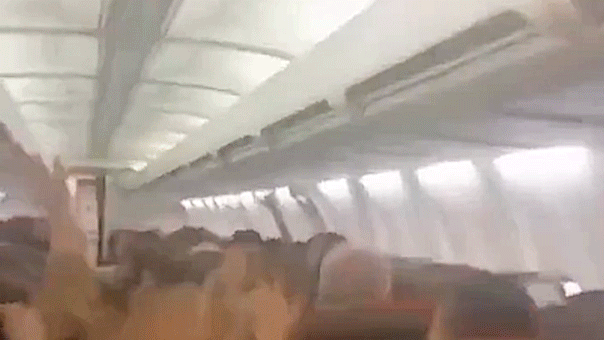 Plane passengers scream in harrowing mid-flight video as violent shaking sends cabin ceiling panels flying
