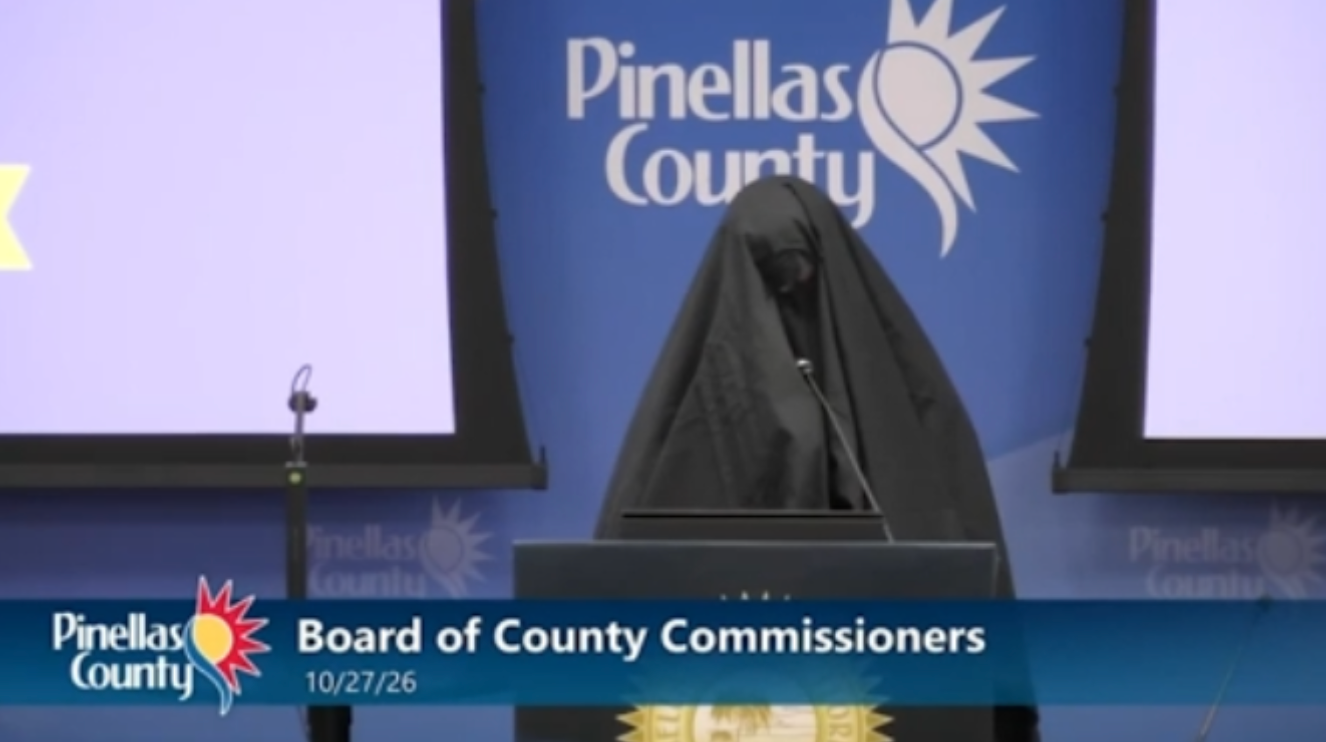 Woman covered in veil escorted out of Florida county meeting after playing call to prayer recording